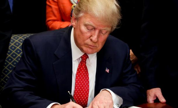El presidente de EE.UU. Donald J. Trump firma una orden ejecutiva para reversar una orden de la administración Obama sobre agua el 28 de febrero de 2017. Efe.