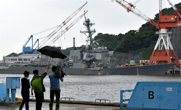 A Japanese TV crew films the damaged US Navy destroyer USS Fitzgerald berthing at Yokosuka Naval Base in Yokosuka, south of Tokyo, Japan, 18 June. Efe.