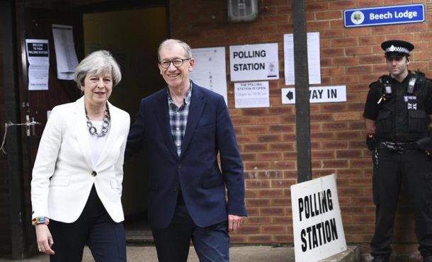 La primera ministra británica, la conservadora Theresa May, y su marido Philip May posan antes de votar en un colegio electoral en Sonning. Efe