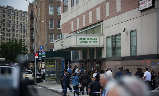Officers gather in front of the building after a shooter opened fire, killing at least one doctor and shooting six others before committing suicide at the Bronx-Lebanon Hospital Center. Efe
