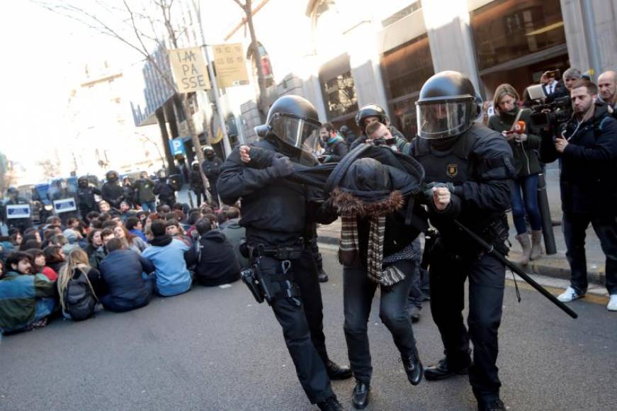 BARCELONA (ESPAÑA), 12.02.2019. Efectivos de los Mossos d'Esquadra desalojan a una de las personas que se han concentrado ante la Fiscalía de Barcelona. Efe