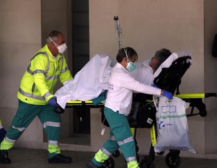 FOTOGRAFÍA. VIZCAYA (ESPAÑA), 24.03.2020. Sanitarios de una ambulancia trasladan a un enfermo con oxígeno al hospital vizcaíno de Cruces, en el País Vasco. Efe