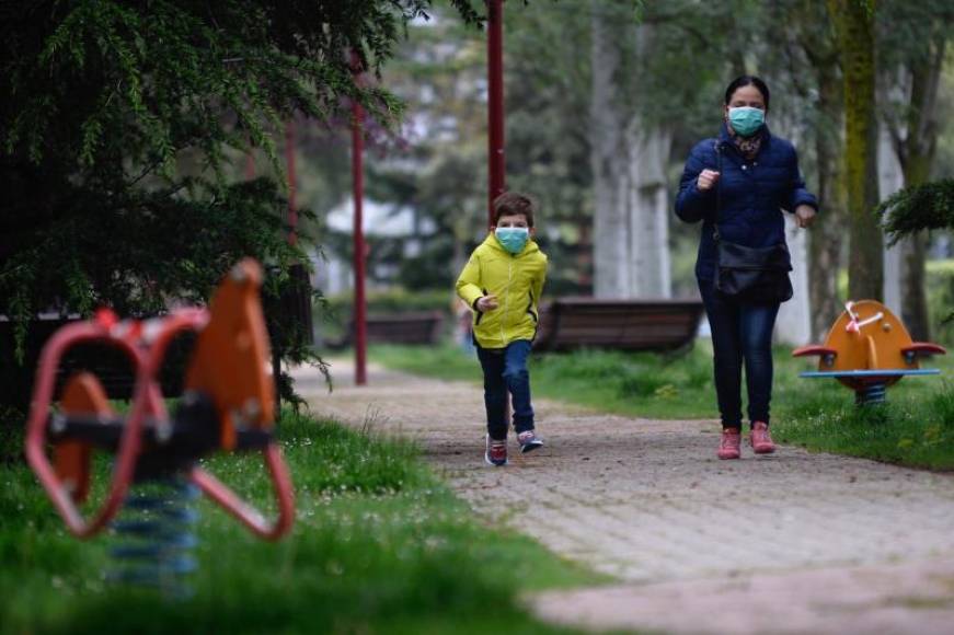 FOTOGRAFÍA. ALLADOLID (ESPAÑA), 26.04.2020. Un niño protegido con una mascarilla corre esta mañana por un parque de la ciudad de Valladolid. efe
