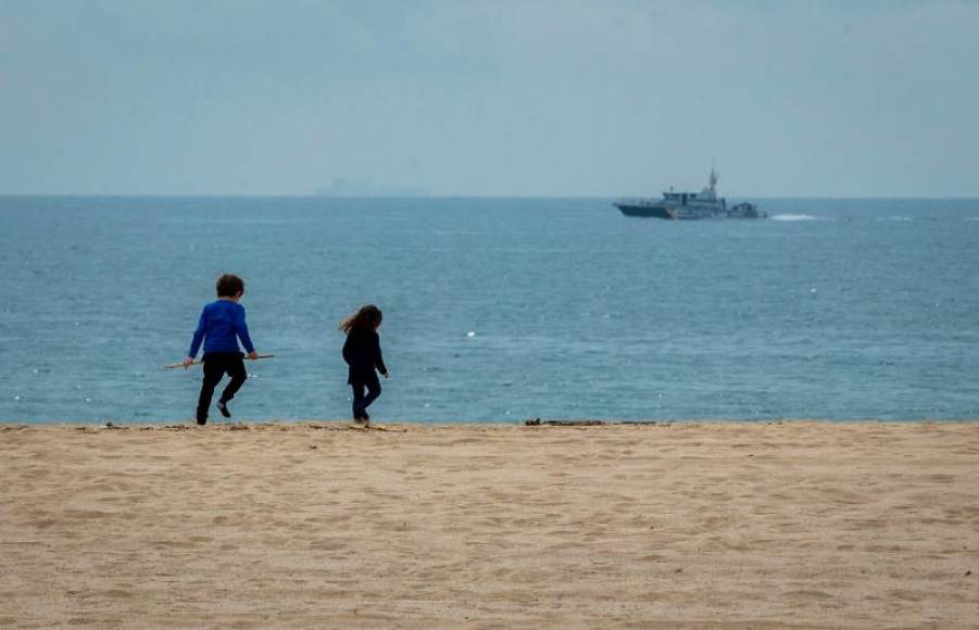 FOTOGRAFÍA. PLAYA EL MASNOU (BARCELONA) ESPAÑA, 29.04.2020. Dos niños juegan en la playa de El Masnou. Efe