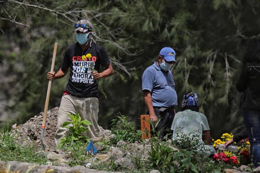 FOTOGRAFÍA. TEGUCIGALPA (HONDURAS), 16.07.2020. Un grupo de personas se despiden después de enterrar un pariente que murió por coronavirus en Tegucigalpa (Honduras). Efe