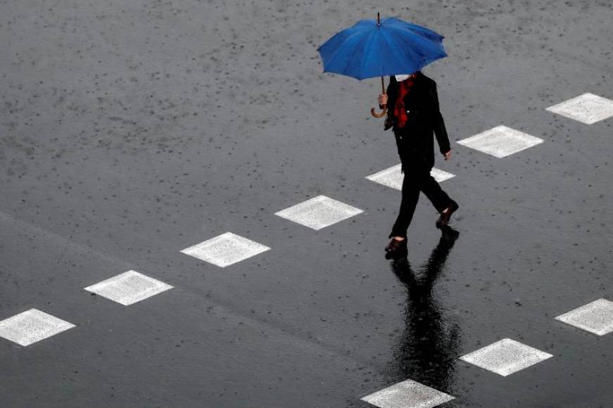 FOTOGRAFÍA. ESPAÑA, 25.02.2021. Una persona camina bajo la lluvia. Efe