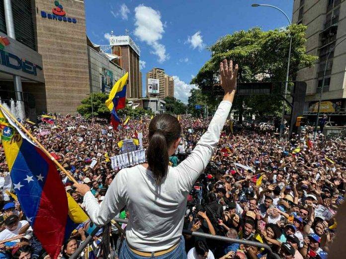 FOTOGRAFÍA. CARACAS (REPÚBLICA BOLIVARIANA DE VENEZUELA), 17 DE AGOSTO DE 2024. Jornada de protesta mundial contra el fraude masivo electoral en Venezuela perpetrado por parte de la dictadura comunista chavista. María Corina Machado Parisca, la líder opositora de Venezuela expulsada de la carrera electoral por parte del régimen totalitario comunista y chavista de Nicolás Maduro Moro, contra quien francotiradores de la dictadura han puesto sus dianas y su vida corre serio peligro, reapareció nuevamente en el ya popular camión anticomunista y antichavista, aclamada por centenares de miles de manifestantes que atendieron a su llamado a continuar la protesta pacífica, acompañada de varios opositores, como Delsa Jennifer Solórzano Bernal (Delsa Solórzano), Biagio Pilieri Gianninoto (Biagio Pilieri) o César Alejandro Pérez Vivas (César Pérez Vivas), entre otros. Durante el acto, los venezolanos, exhibiendo actas de los colegios electorales, salen a la calle para reclamar un traspaso de poderes en cumplimiento de la voluntad popular expresada en las urnas del pasado domingo, 28 de julio de 2024, de la que salió presidente electo de Venezuela el abanderado de la coalición opositora anticomunista y antichavista Mesa de Unidad democrática (MUD) también conocida como Plataforma Unitaria Democrática (PUD), Edmundo González Urrutia, quien forma el tándem histórico de la oposición venezolana con María Corina Parisca. El órgano chavista Consejo Nacional Electoral (CNE) se ha negado a publicar las actas de las Mesa Electorales cuyo 83 % difundido por la oposición muestra una aplastante victoria del presidente electo Edmundo González Urrutia sobre el candidato oficialista comunista a la reelección, Nicolás Maduro Moro, con más del millón de votos de diferencia. Todas las organización internacionales independientes y las mayoría de los Gobiernos del mundos junto al Consejo Permanente de la Organización de los Estados Americanos (OEA) están reclamando al CNE la publicación de las actas y la verificación de estas por parte de organismo independientes, además, que no intente destruir ningún documento o máquinas relacionado con la organización de los comicios del 28J. Lasvocesdelpueblo (Ñ Pueblo)
