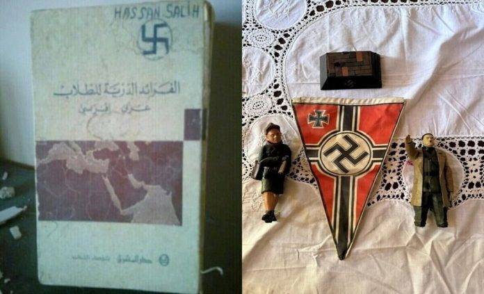 FOTOGRAFÍA. AITA AL-SHAAB (SUR DEL LÍBANO), 01 DE NOVIEMBRE DE 2024. Las Fuerzas de Defensa de Israel (FDI), integrantes del Ejército de la Tierra Santa (Tzáhal), han dado con un nuevo hallazgo que confirma el islamofascismo de los grupos antisemitas que conforman la cruzada anti-israelí liderada por la tiranía de los ayatolás —junto a sus aliados de la antiIsrael en el Occidente- desde la República Islámica de Irán hasta el Oriente Medio: en la Franja palestina de Gaza, con el Hamas ISIS, y en el sur del Líbano, con el Hezbolá ISIS. Se trata de cuadernos de adoctrinamiento nazi y bandera nazi con su cruz gamada (la esvástica); de muñecos SS, —los llamados "Schutzstaffel", organización paramilitar y política al servicio del líder del nazismo y del Tercer Reich alemán, Adolf Hitler, y al servicio del Partido Nacionalsocialista Obrero Alemán (NSDAP) en la Alemania nazi; también conocidos como "Einsatzgruppen" o "grupos operativos" o también «grupos de operaciones», que simplemente eran un conjunto de escuadrones de ejecución itinerantes especiales de la Alemania Nazi; unos escuadrones de la muerte que actuaron en Austria de 1938, Checoslovaquia (1939), en Polonia (1939) y la Unión de Repúblicas Socialistas Soviéticas (URSS) en 1941 masacrando masivamente en cámaras de gas o fusilamientos grupales a los civiles judíos, pegando primero el tiro en la nuca de los niños, que sus padres estaban obligados a levantarlos lo más arriba posible, y después fusilando a los padres de los críos—; entre otros, objetos como cajas de adorno siempre con la esvástica fascista, capturados por los guerreros santos durante la operación terrestre en contra el "enemigo" terrorista en el sur del Líbano: el Hezbollah (Hezbolá). Tzáhal/Lasvocesdelpueblo (Ñ Pueblo)