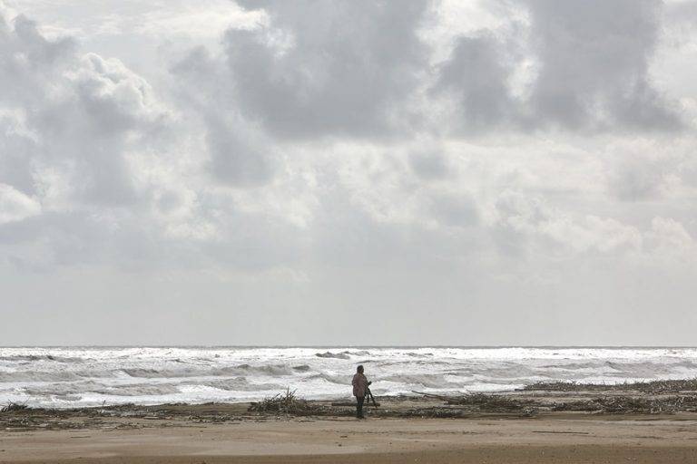 FOTOGRAFÍA. CULLERA (VALENCIA) COMUNIDAD VALENCIANA (REINO DE ESPAÑA, 14/11/2024.- Una mujer camina por la playa, este jueves, en Cullera, ciudad que se ha visto afectada por fuertes lluvias esta madrugada aunque sin causar graves incidentes. AEMET ha bajado el aviso de fenómenos meteorológicos adversos de rojo a naranja en la zona mas afectada por la DANA de hace dieciséis días. Efe