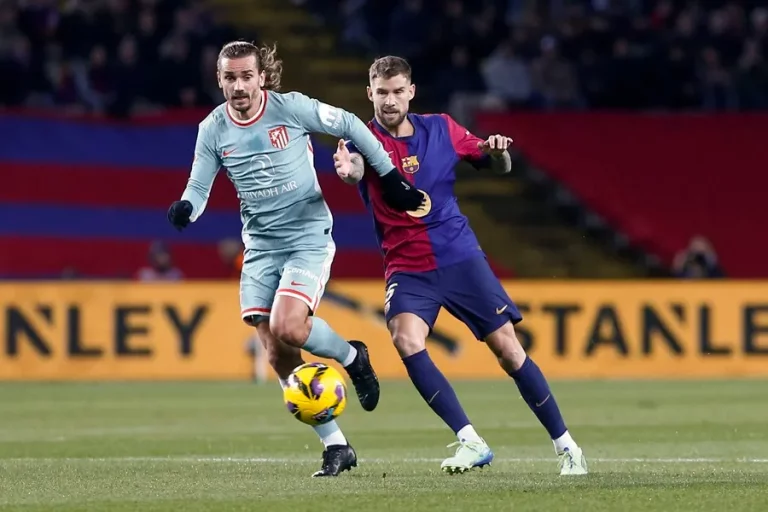 FOTOGRAFÍA. BARCELONA (REINO DE ESPAÑA), 21 DE DICIEMBRE DE 2024. El defensa del FC Barcelona Íñigo Martínez (d) persigue al francés Antoine Griezmann, del Atlético de Madrid, durante el partido de la jornada 18 de LaLiga. Efe
