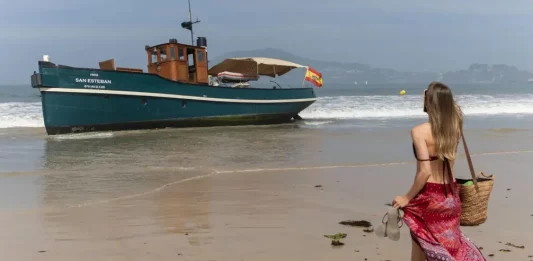 FOTOGRAFÍA. NIGRÁN (GALICIA) REINO DE ESPAÑA, 26 DE AGOSTO DE 2025. Los bañistas de la playa de Playa América en Nigrán, en la provincia de Pontevedra (Galicia) Reino de España se vieron sorprendidos al descubrir un antiguo vapor varado en la arena. Efe