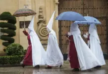 Descenso de temperatura y chubascos generalizados este viernes FOTOGRAFÍA. CÓRDOBA (ANDALUCÍA) REINO DE ESPAÑA, 25 DE MARZO DE 2024. Martes Santo de chubascos y lluvias en toda España. Semana Santa. Unos nazarenos de la Hermandad de La Sentencia se protegen de la lluvia con paraguas mientras caminan hacia su templo este lunes en Córdoba. Efe